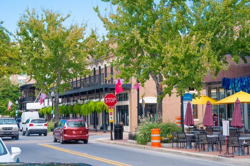 Downtown Pensacola street scene with commercial buildings and roadway environment relevant to local land surveying and site development.
